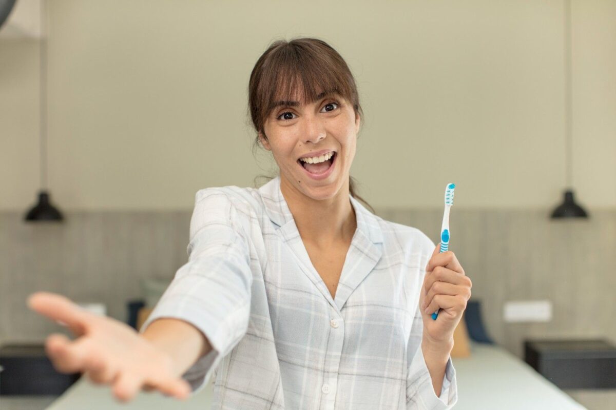 women showing toothbrush