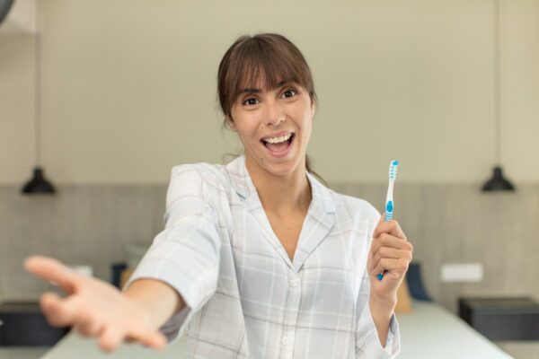 women showing toothbrush